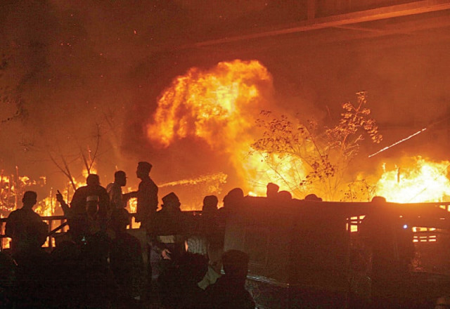 firefighters struggle to control huge fire that broke out in a makeshift village under the teen hatti bridge on thursday photo online firefighters struggle to control huge fire that broke out in a makeshift village under the teen hatti bridge on thursday photo online