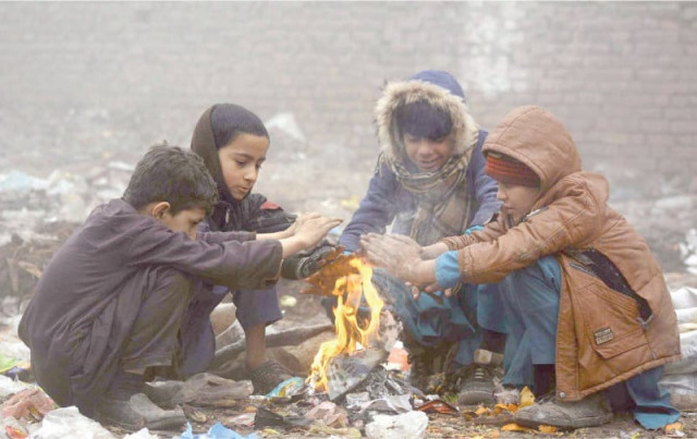 children sit around a fire to keep warm during foggy weather in peshawar photo app children sit around a fire to keep warm during foggy weather in peshawar photo app