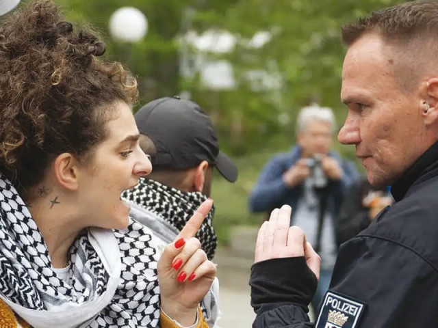 a protester at berlin s freie universit t arguing with the police photo publicity a protester at berlin s freie universit t arguing with the police photo publicity