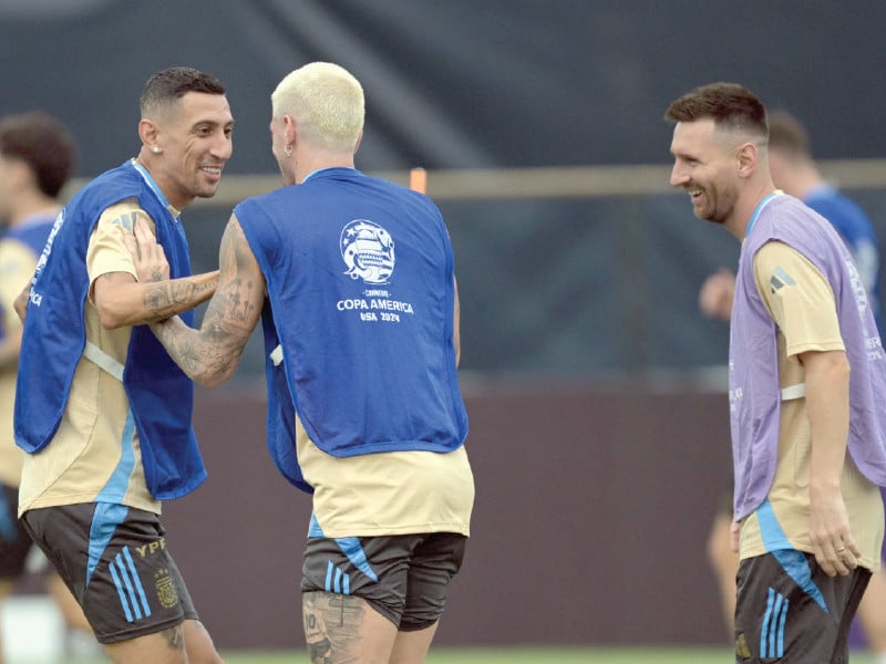 argentina s forward angel di maria l laughs next to midfielder rodrigo de paul c and forward lionel messi during a training session one day before the conmebol 2024 copa america tournament football final against colombia in miami photo afp