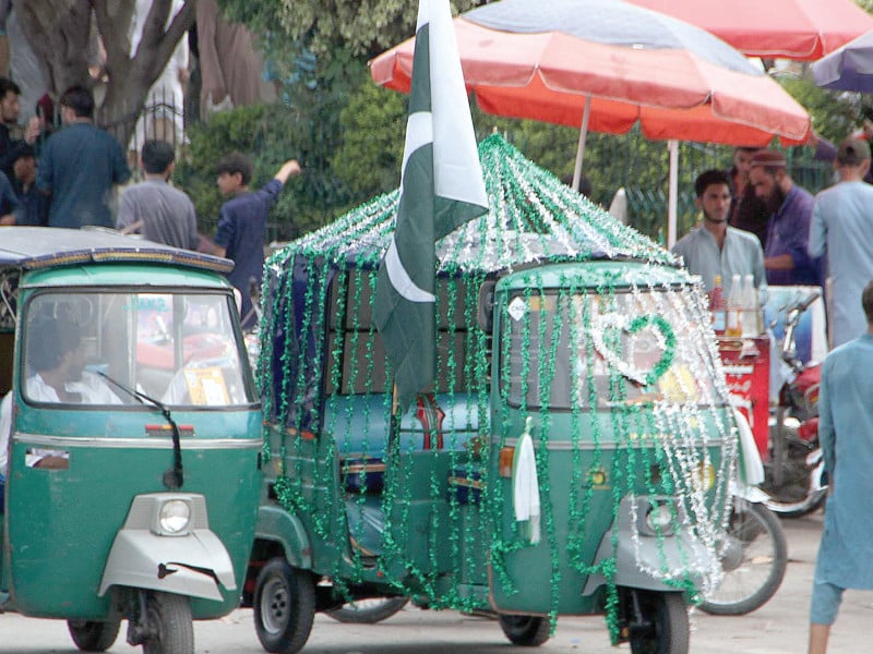 to make sure his three wheeler stands out while taking part in an independence day rally a rickshaw driver has dressed his vehicle to the nines with all manner of decorative items photo ppi