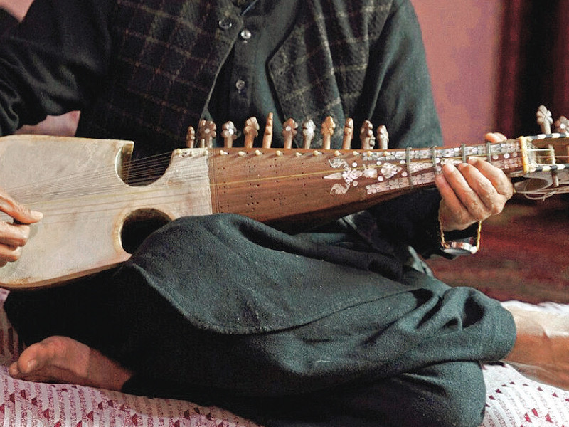 majid strums his lute type chordophone at home photo afp