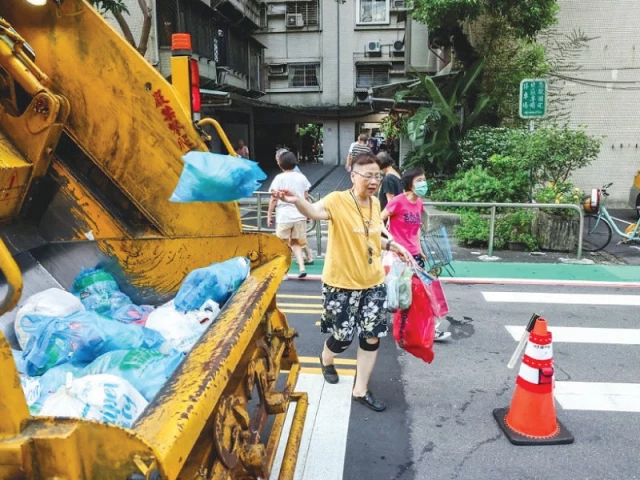 residents hear the music and emerge with their garbage together photo file