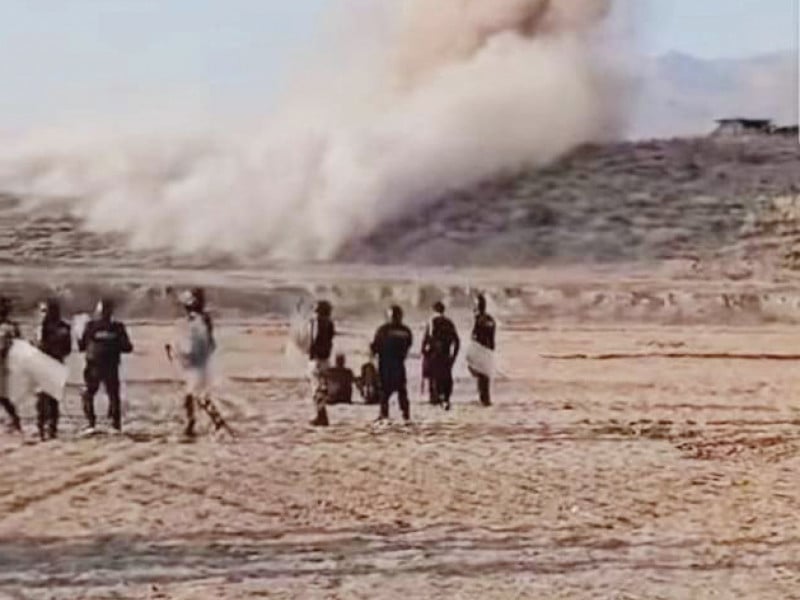 members of a law enforcement agency look on as smoke billows from a bunker dismantled in kurram district photo express