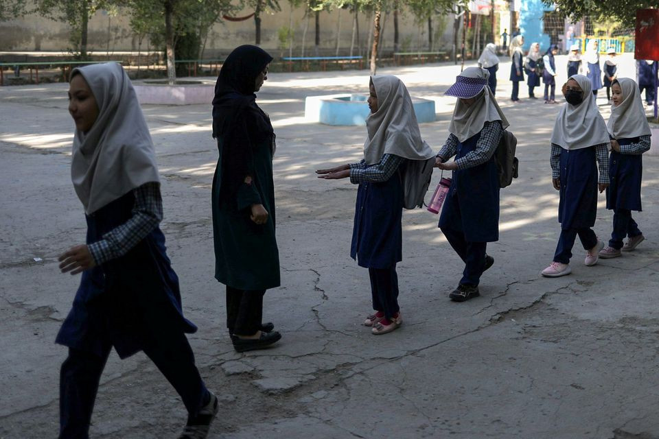 a teacher checks nail hygiene of the students at a school in kabul afghanistan september 18 2021 photo reuters