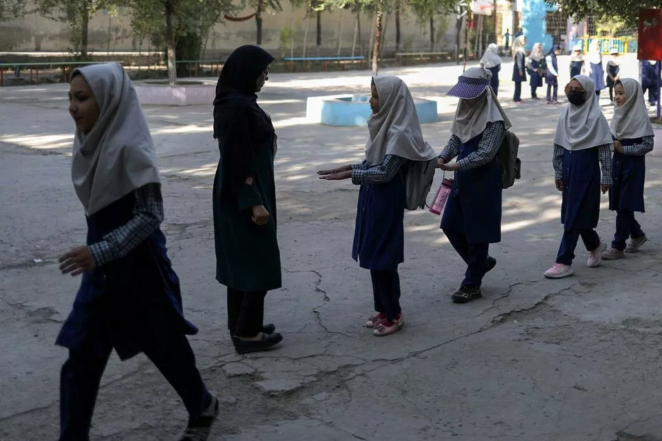 a teacher checks nail hygiene of the students at a school in kabul afghanistan september 18 2021 photo reuters a teacher checks nail hygiene of the students at a school in kabul afghanistan september 18 2021 photo reuters