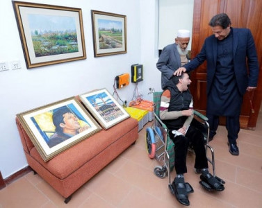 artist suffering from cerebral palsy presents portraits to pm imran