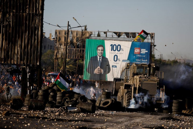 palestine protestors throw stones during an anti israel protest over cross border violence between palestinians in gaza and the israeli military near hawara checkpoint near nablus in the israeli occupied west bank may 18 2021 photo reuters palestine protestors throw stones during an anti israel protest over cross border violence between palestinians in gaza and the israeli military near hawara checkpoint near nablus in the israeli occupied west bank may 18 2021 photo reuters