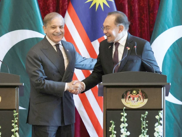 prime minister shehbaz sharif shares a light moment with his malaysian counterpart anwar ibrahim in putrajaya photo reuters