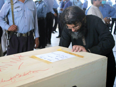 bereft relatives collect remains of loved ones