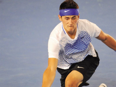 tennis tomic moves into 2nd round