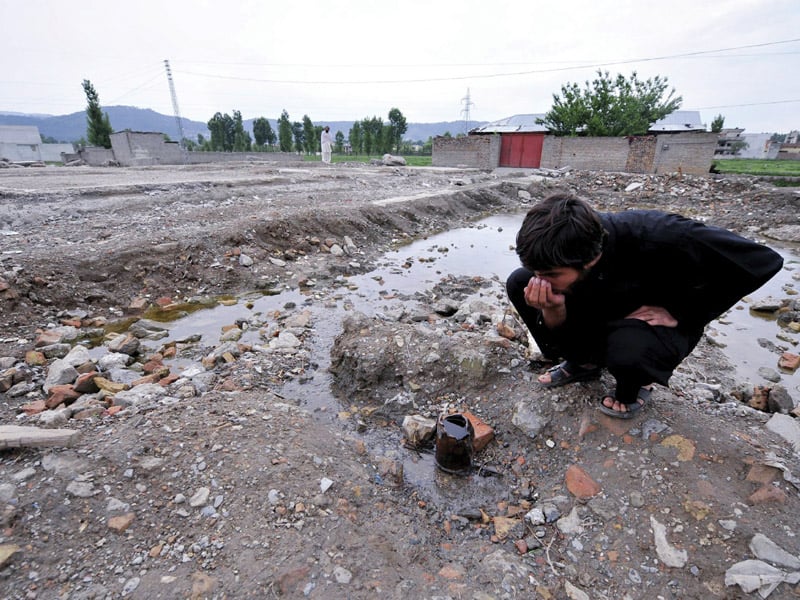 gushing water brings devotees visitors to bin laden compound