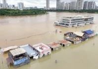 flooded shops along a submerged riverside walk are seen by the overflowing yongjiang river in nanning china photo afp