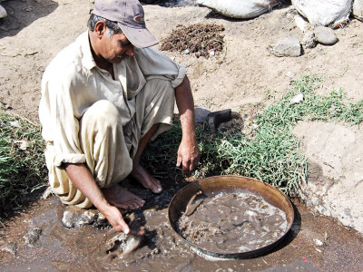 mining gold from garbage is the only way neyaras know to make money