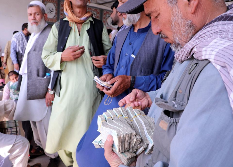 afghan money exchange dealers wait for customers at a money exchange market following banks and markets reopening after the taliban took over in kabul afghanistan september 4 2021 reuters