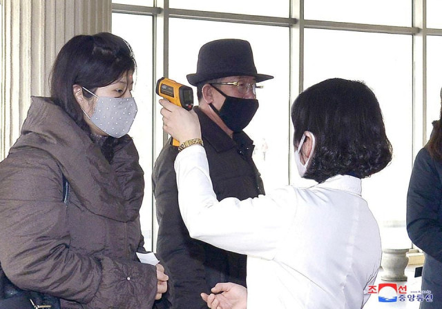 volunteers carry out temperature screening during an anti virus campaign in pyongyang north korea in this image released by north korea s korean central news agency kcna on march 4 2020 kcna via reuters volunteers carry out temperature screening during an anti virus campaign in pyongyang north korea in this image released by north korea s korean central news agency kcna on march 4 2020 kcna via reuters