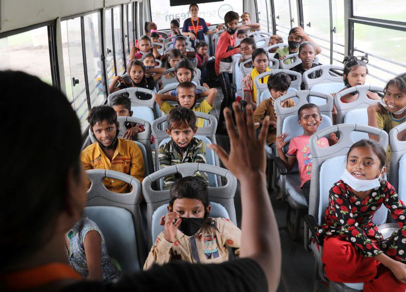 a woman teaches children inside a parked bus run by tejasasia an ngo using hope buses as mobile classrooms for children living in slums on the floodplains of the yamuna river in new delhi india august 9 2021 photo reuters