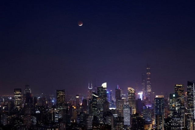 lunar eclipse rises over the skyline of shanghai china november 19 2021 photo reuters lunar eclipse rises over the skyline of shanghai china november 19 2021 photo reuters