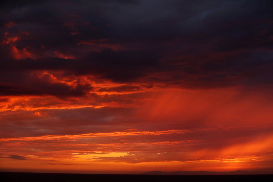 Rain falls over the Pacific Ocean as the sun sets in Laguna Beach, Calif, Oct 24. PHOTO: REUTERS