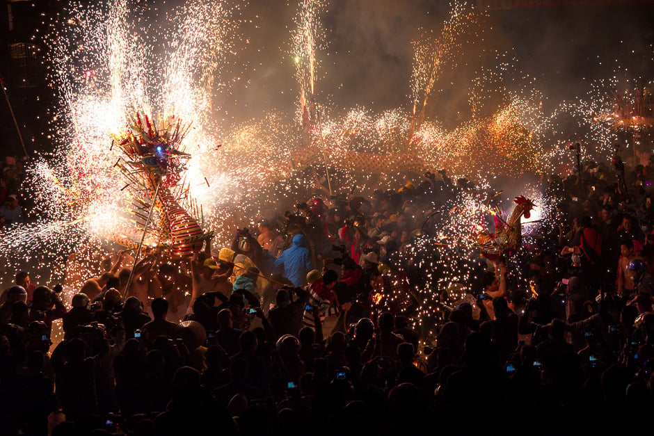 People watch a fire dragon and a fire rooster made of lanterns, firecrackers and fireworks as performers carry the lanterns to perform dances to celebrate, Fengshun county, Guangdong province. PHOTO: REUTERS