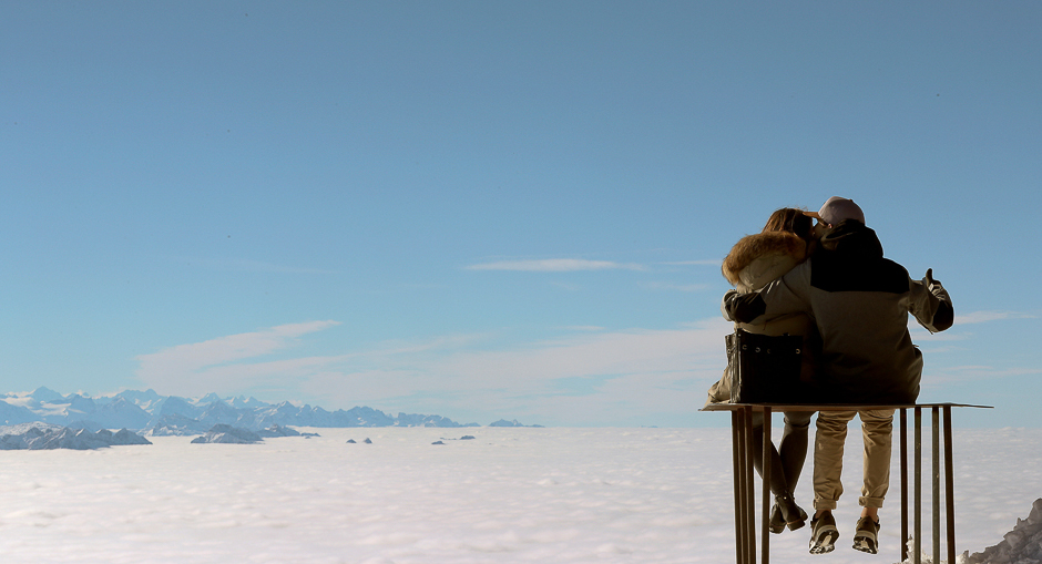 A couple relaxes as they sit on a table on the peak of Mount Saentis (2502 metres/8209 feet above sea level) during sunny autumn weather near Schwaegalp in the eastern Swiss Alps, Switzerland. PHOTO: REUTERS
