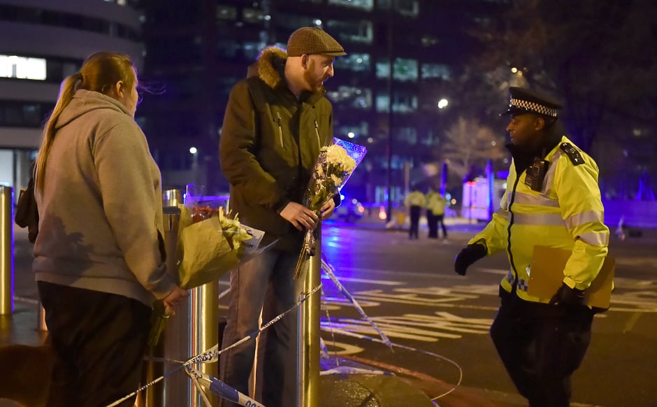 People leave flowers at the scene after an attack on Westminster Bridge in London, Britain. PHOTO: REUTERS