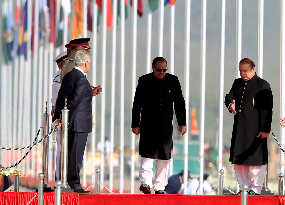 Prime Minister Nawaz Sharif (R) and President Mamnoon Hussain (C) arrive to attend the Pakistan Day military parade in Islamabad. PHOTO: REUTERS