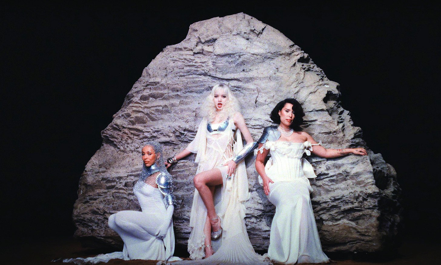 the three artists undergo a transformation in the music video photo file