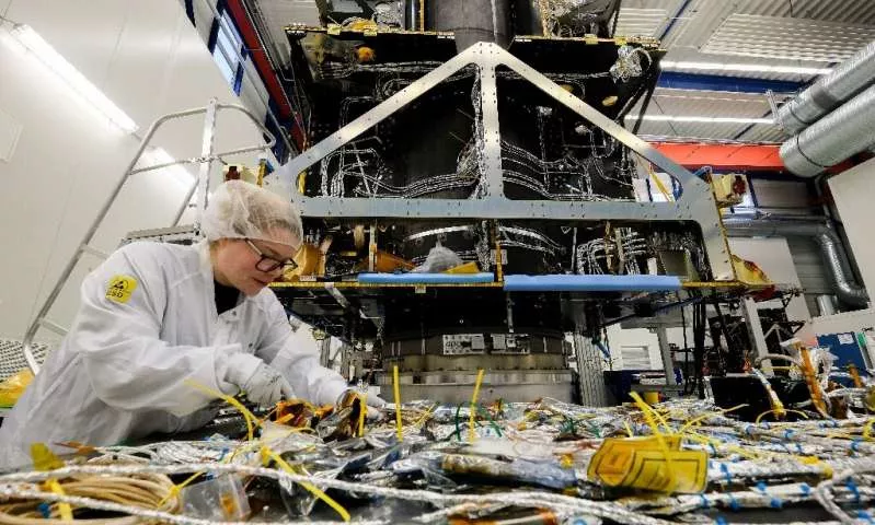 an employee works on a satellite at ohb space systems a german firm that is holding its own against bigger european comptetitors patrik stollarz photo afp an employee works on a satellite at ohb space systems a german firm that is holding its own against bigger european comptetitors patrik stollarz photo afp