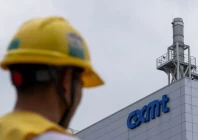 a man wearing a yellow protective helmet walks next to a production facility of china s top memory chipmaker cxmt with company s logo on the facade in beijing china july 29 2026 reuters