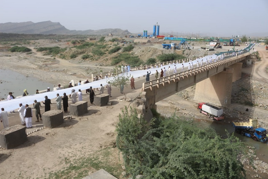 People hold the the 1600ft long, 15ft wide flag. PHOTO: EXPRESS