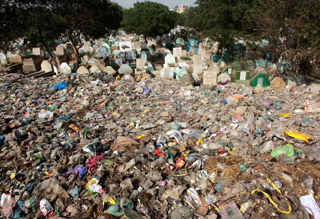 the situation at the graveyard is dire as the garbage is affecting the graves photo athar khan express