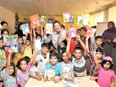 summer book club excitement sweeps over children as qavi khan reads to them