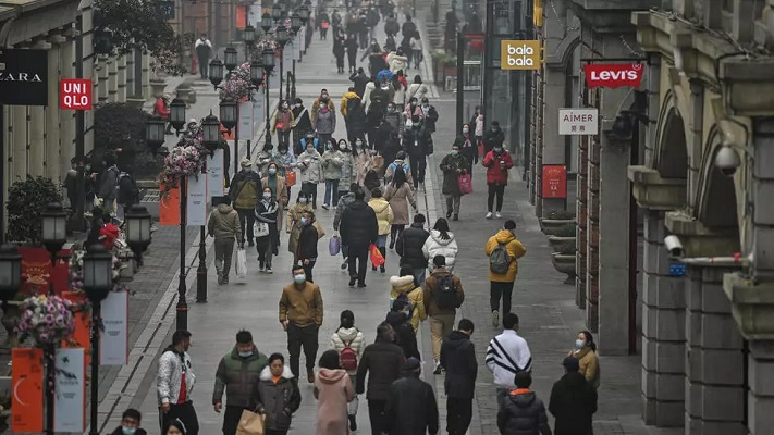 people walk along a street in wuhan on saturday one year after the city went into lockdown to curb the spread of covid 19 photo afp