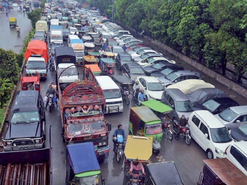 citizens stuck in traffic on sheranwala road as heavy monsoon rains lash the provincial capital photo online