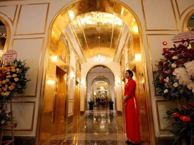an employee in traditional dress is seen in the newly inaugurated dolce hanoi golden lake luxury hotel which features gold plated exteriors and interiors in hanoi vietnam photo reuters an employee in traditional dress is seen in the newly inaugurated dolce hanoi golden lake luxury hotel which features gold plated exteriors and interiors in hanoi vietnam photo reuters