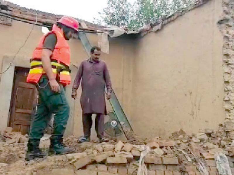 a rescuer inspects debris on the spot where the roof and walls of a building collapsed after downpour in faisalabad such incidents continue unabated in punjab causing damage to property as rains lash the region photo express