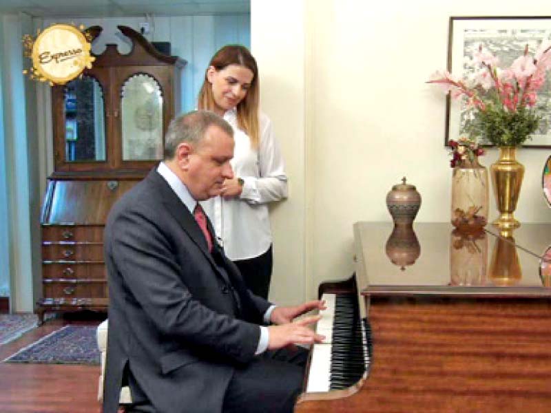 italian ambassador andreas ferrarese plays piano as his wife looks on during the morning show expresso photo express