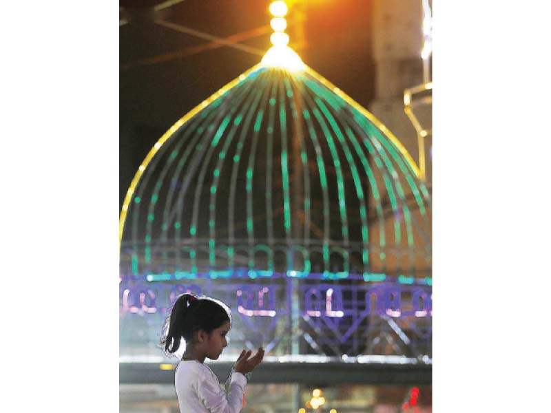 a child offers a prayer at a mosque in karachi on the eve of eid miladun nabi photo inp