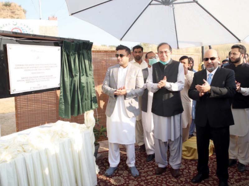 special assistant to the prime minister on overseas pakistanis syed zulfi bukhari unveils the plaque for the plot handing over ceremony at the opf housing scheme photo express