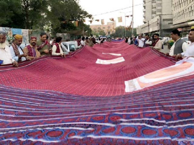 people display the world s largest ajrak outside karachi press club ahead of sindh culture day photo express file people display the world s largest ajrak outside karachi press club ahead of sindh culture day photo express file