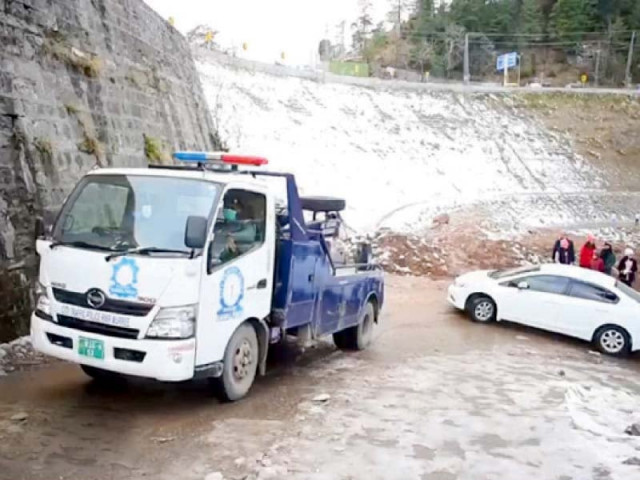 a police truck tows a stranded car in murree during snowfall photo express a police truck tows a stranded car in murree during snowfall photo express