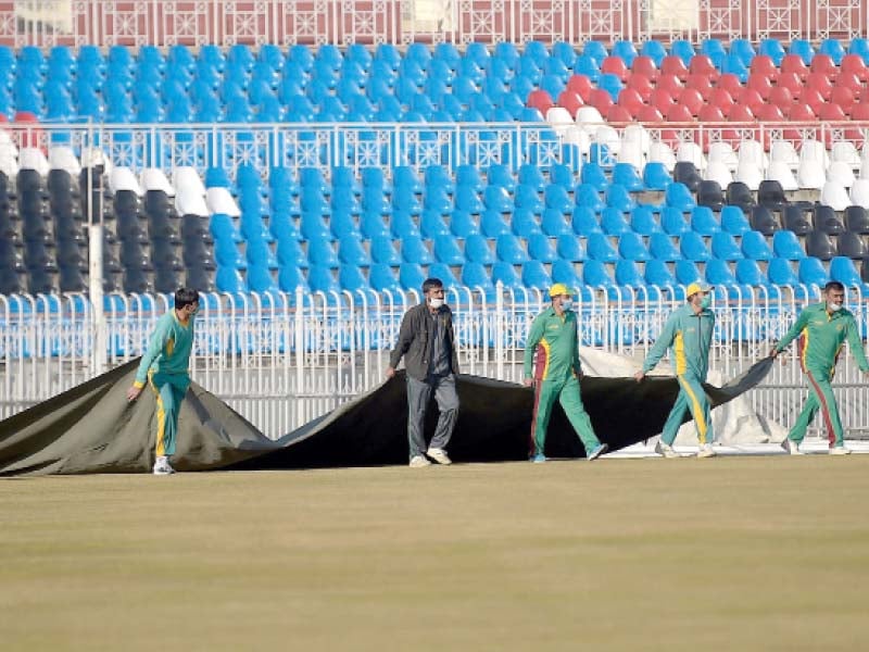 groundsmen prepare for the upcoming test match between pakistan and south africa at the cricket stadium in rawalpindi on saturday photo afp