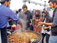 visitors buy fried chicken from a stall at the islamabad taste food festival under way at the convention centre photo online