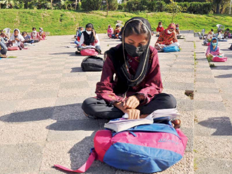 with educational institutions closed given the rising covid cases mask clad students observe all sops as they attend an open air class arranged by an informal school in the federal capital photo nni