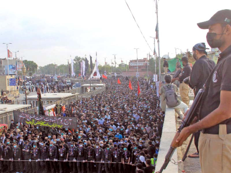 participants of a mourning procession wear face masks on a youm e ali observed mid pandemic as police personnel stand guard to ensure their security photo online