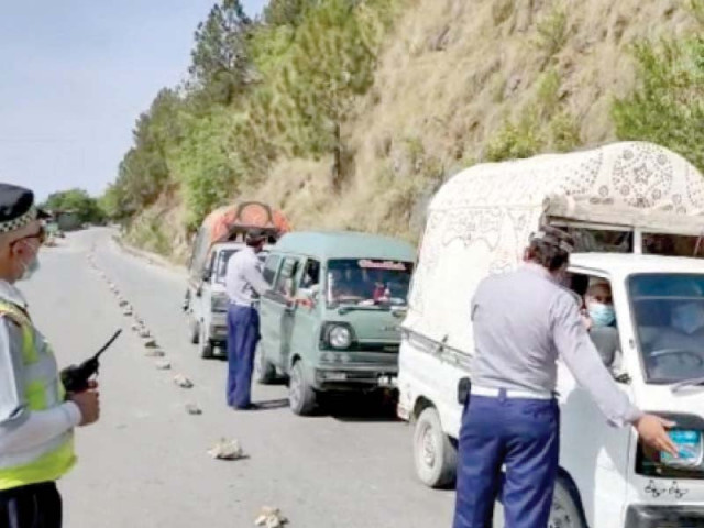 district police officials stop vehicles driving up north as tourist spots remained closed after eid holidays in abbottabad pho to ppi district police officials stop vehicles driving up north as tourist spots remained closed after eid holidays in abbottabad pho to ppi