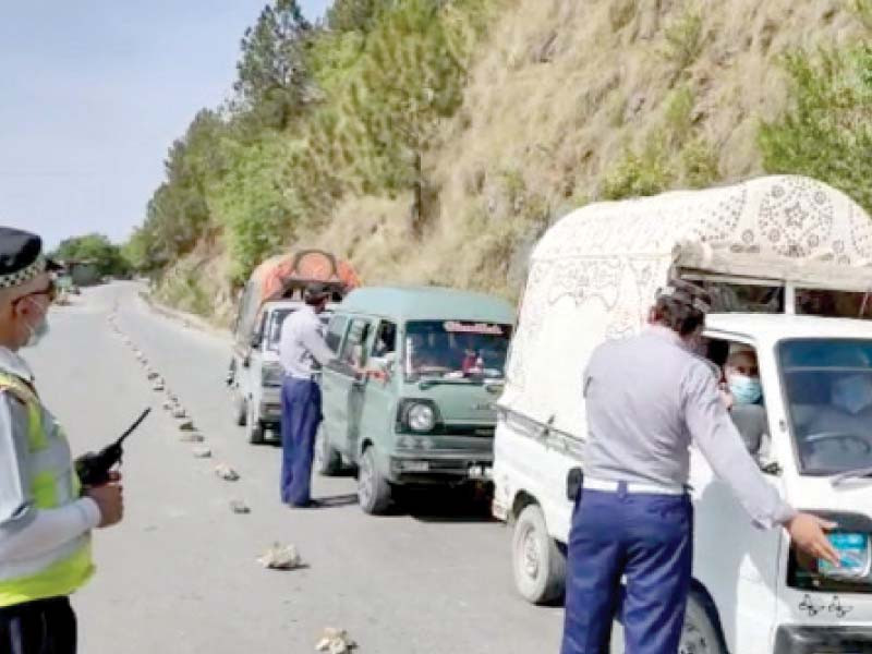 district police officials stop vehicles driving up north as tourist spots remained closed after eid holidays in abbottabad pho to ppi