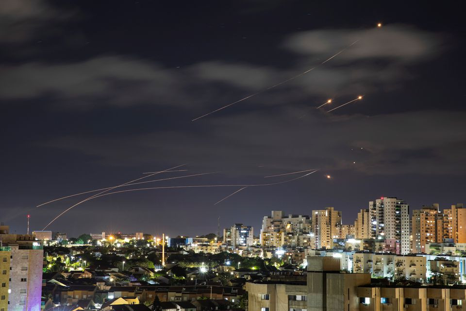 Streaks of light are seen as Israel's Iron Dome anti-missile system intercepts rockets launched from the Gaza Strip towards Israel, as seen from Ashkelon, Israel May 17. PHOTO: REUTERS