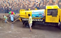 wasa workers pump out rainwater accumulated at committee chowk in rawalpindi photo express file